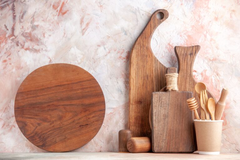 front-view-wooden-brown-cutting-boards-different-sizes-forms-standing-wall-colorful-surface-min